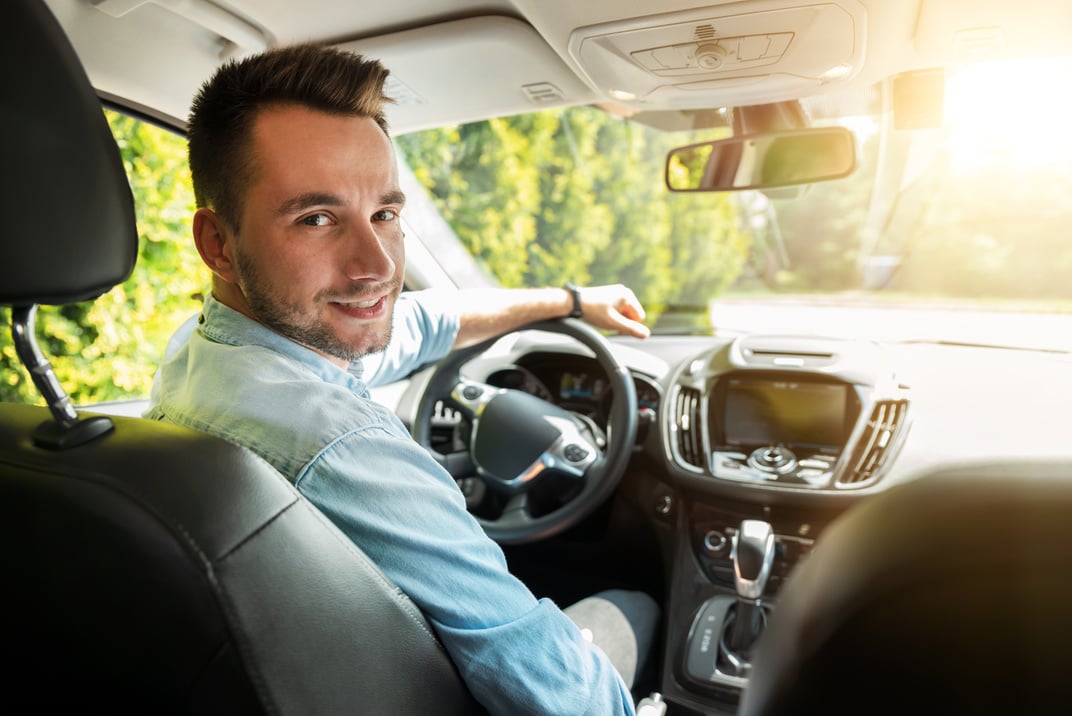 Young male driver behind the wheel.